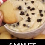 A hand holds a cookie dipped in rich Chocolate Chip Dip, topped with extra chocolate chips; text reads "5 Minute Chocolate Chip Dip.