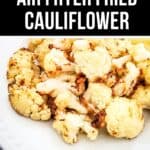 A white plate filled with golden-brown air fryer fried cauliflower florets sits beneath a text banner reading "Crispy Air Fryer Fried Cauliflower." Enjoy this delicious, healthy twist on classic comfort food.