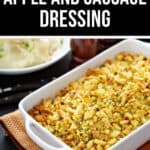 A white baking dish filled with golden Apple and Sausage Dressing sits on a table, accompanied by creamy mashed potatoes and savory gravy in the background.