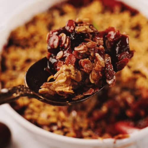 A casserole dish with apple blueberry crisp.