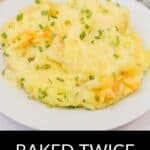 A serving of Baked Twice Mashed Potatoes garnished with chopped chives on a white plate, offering rich flavor and creamy texture in every bite.