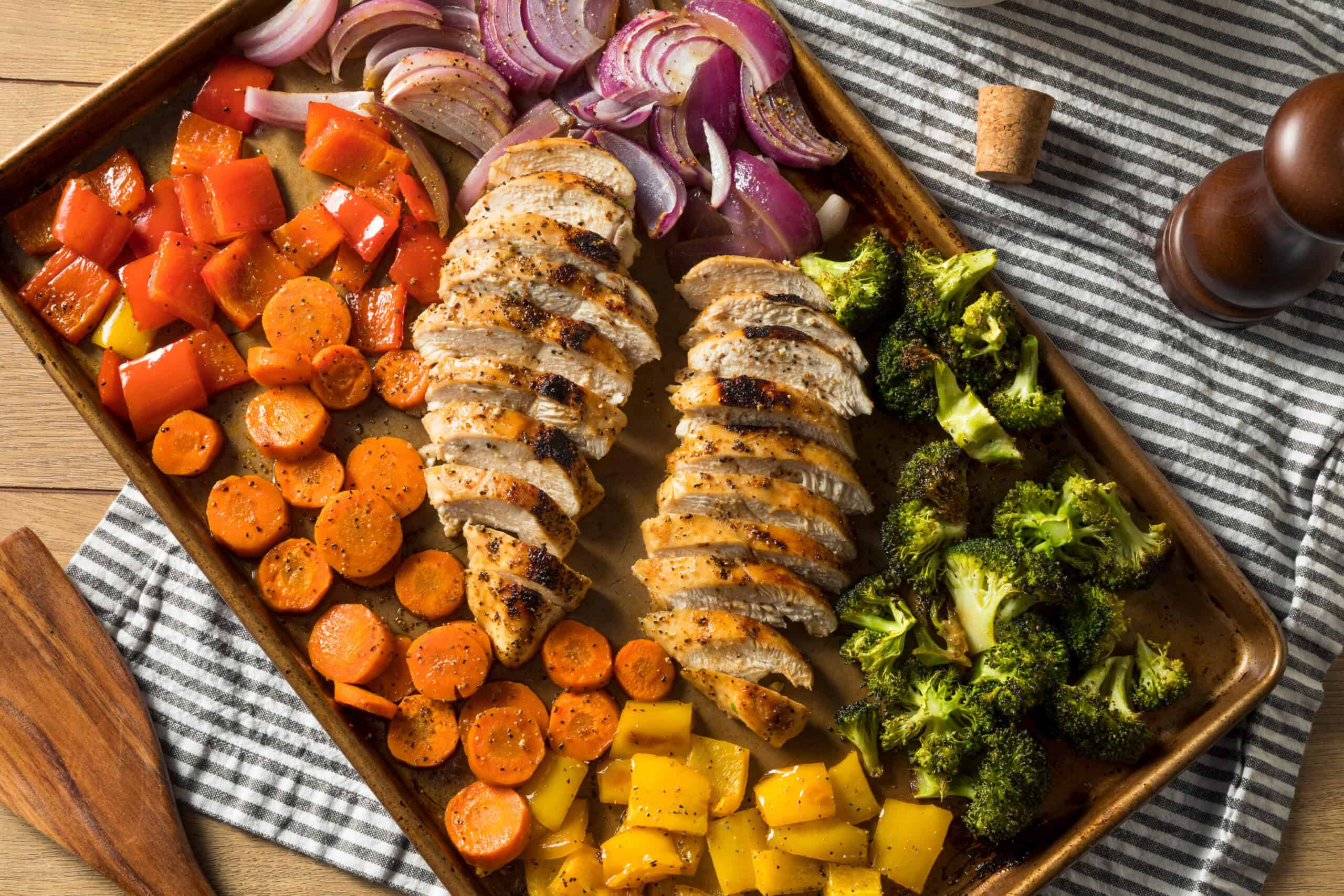 chicken and vegetables on a sheet pan.