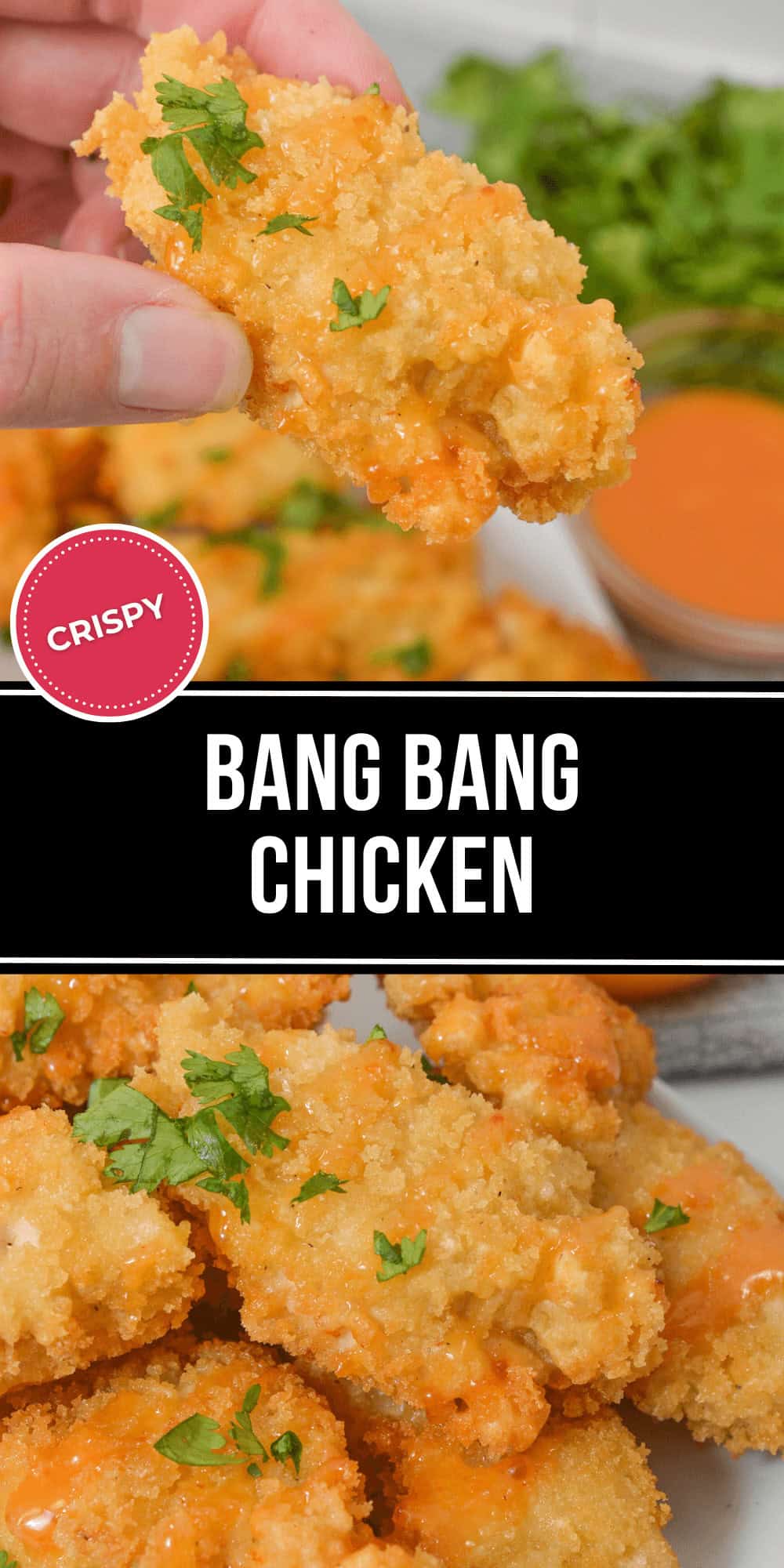 A close-up shows a hand holding crispy Bang Bang Chicken drizzled with tangy orange sauce, resting on a plate. Garnished with fresh green herbs, the scene is completed with a bowl of extra sauce and greens in the background.