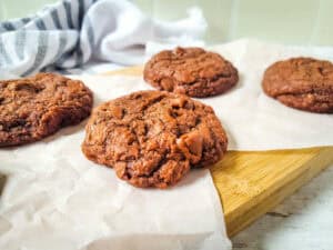 A chewy brownie cake cookie on parchment paper.