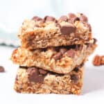 A stack of caramel chocolate oat bars with chocolate chips.
