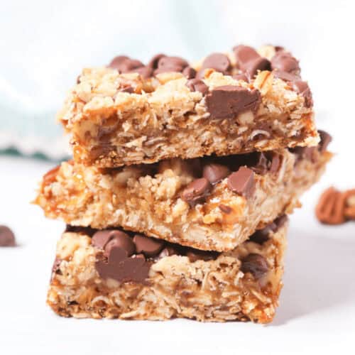 A stack of caramel chocolate oat bars with chocolate chips.