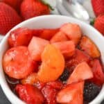 A white bowl of the cherry jello fruit salad.