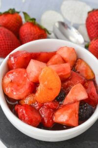 A white bowl of the cherry jello fruit salad.