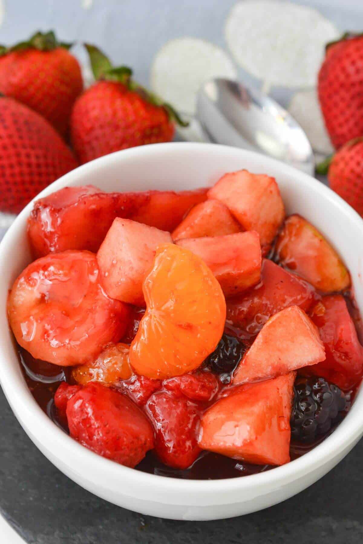 A white bowl of the cherry jello fruit salad.