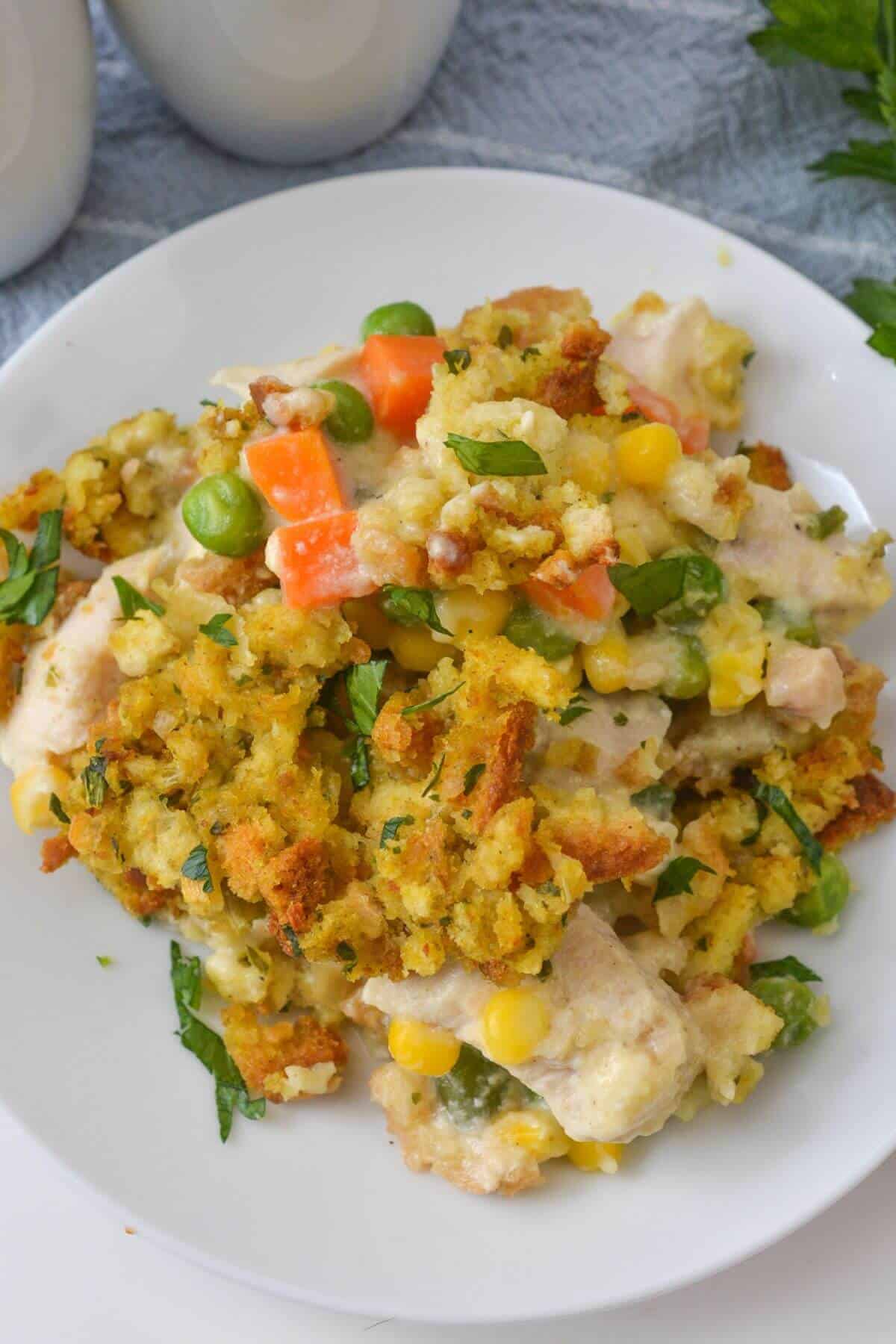 Savor a delightful dinner featuring a medley of mixed vegetables, tender chicken, and savory stuffing, all perfectly seasoned with carrots, peas, corn, and aromatic herbs.