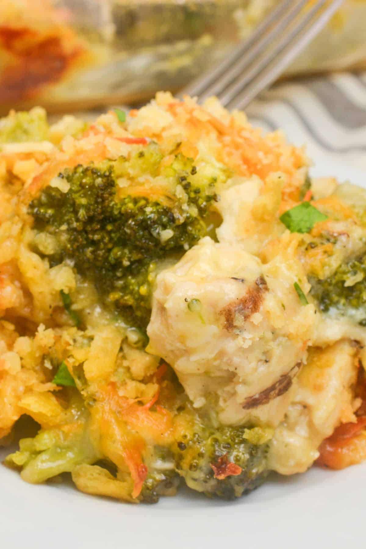 Close-up of a cheesy Chicken Broccoli Divan casserole topped with crispy breadcrumbs on a white plate.