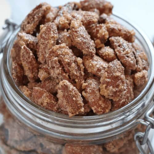 A glass jar of the cinnamon roasted nuts.