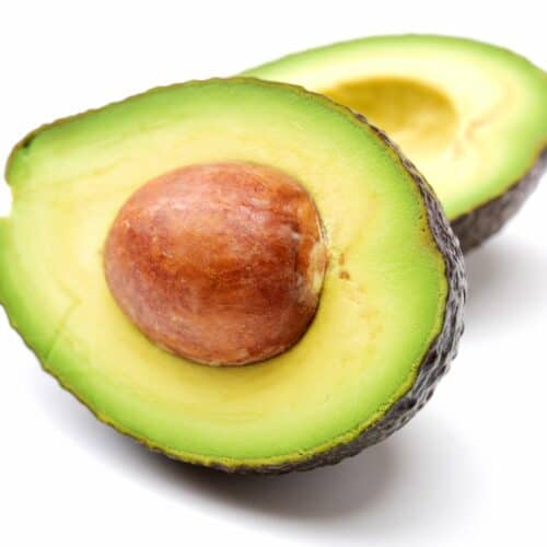 An avocado with its pit exposed.