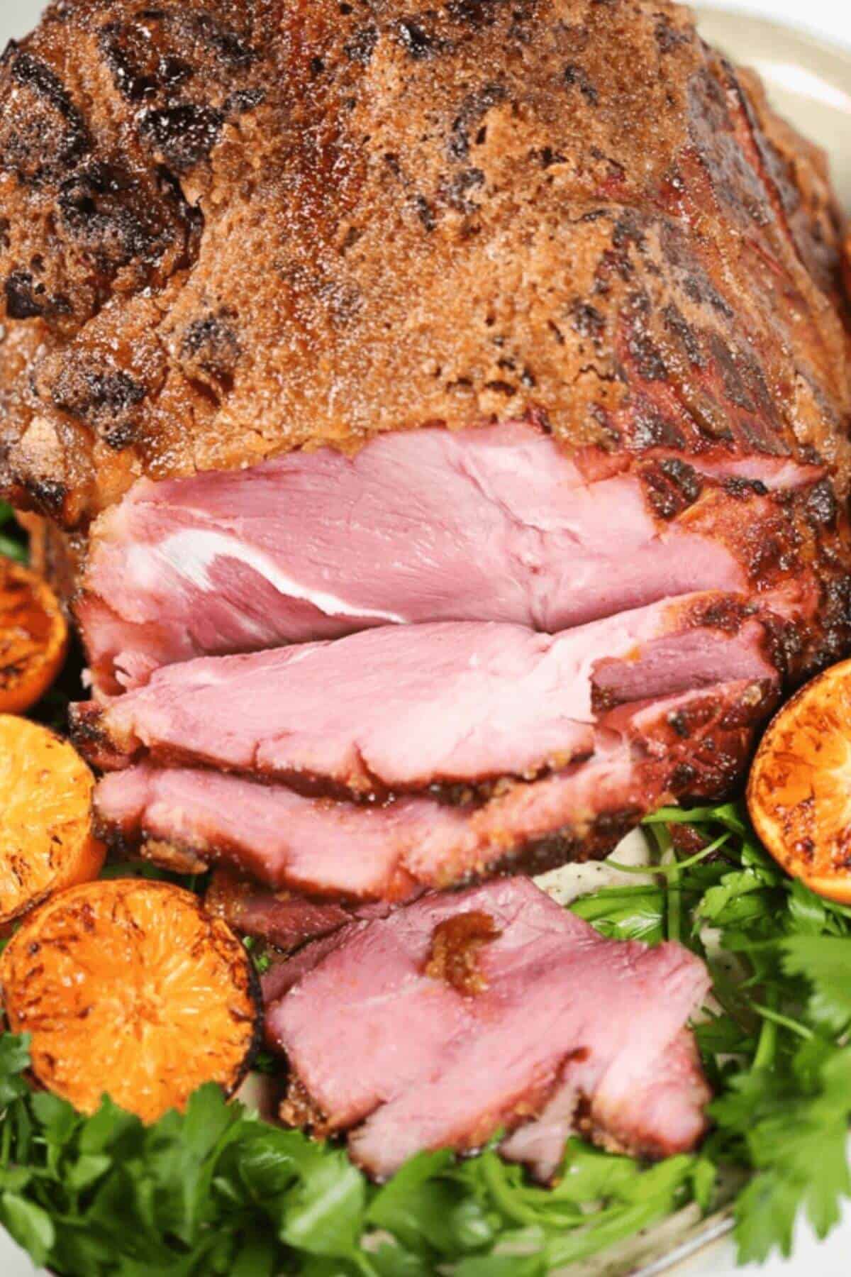 A crispy brown crust on the meat, is elegantly garnished with grilled orange slices and fresh parsley.