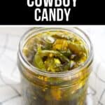 A glass jar filled with sliced green jalapeños in syrup sits on a white and black checkered cloth. The label above reads "Spicy Cowboy Candy," highlighting this classic sweet-and-spicy Cowboy Candy treat.
