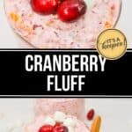 A glass filled with creamy Cranberry Fluff dessert, topped with cranberries and mini marshmallows. A wooden spoon rests beside the glass—perfect for a festive holiday dessert or sweet cranberry salad treat.