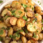 A bowl of veggies on a wooden surface.