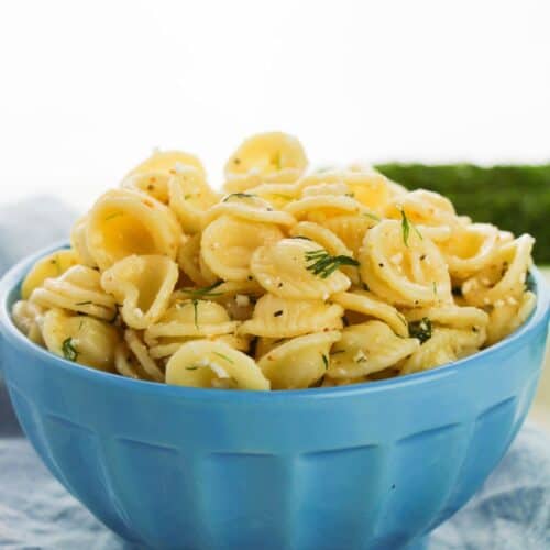 A blue dish of the dill pasta salad with feta cheese.