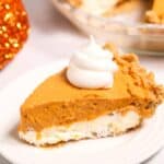 A slice served on a white plate; the rest of the pie is visible in the background.