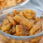 A bowl of cinnamon and brown sugar fruit in a clear glass bowl.