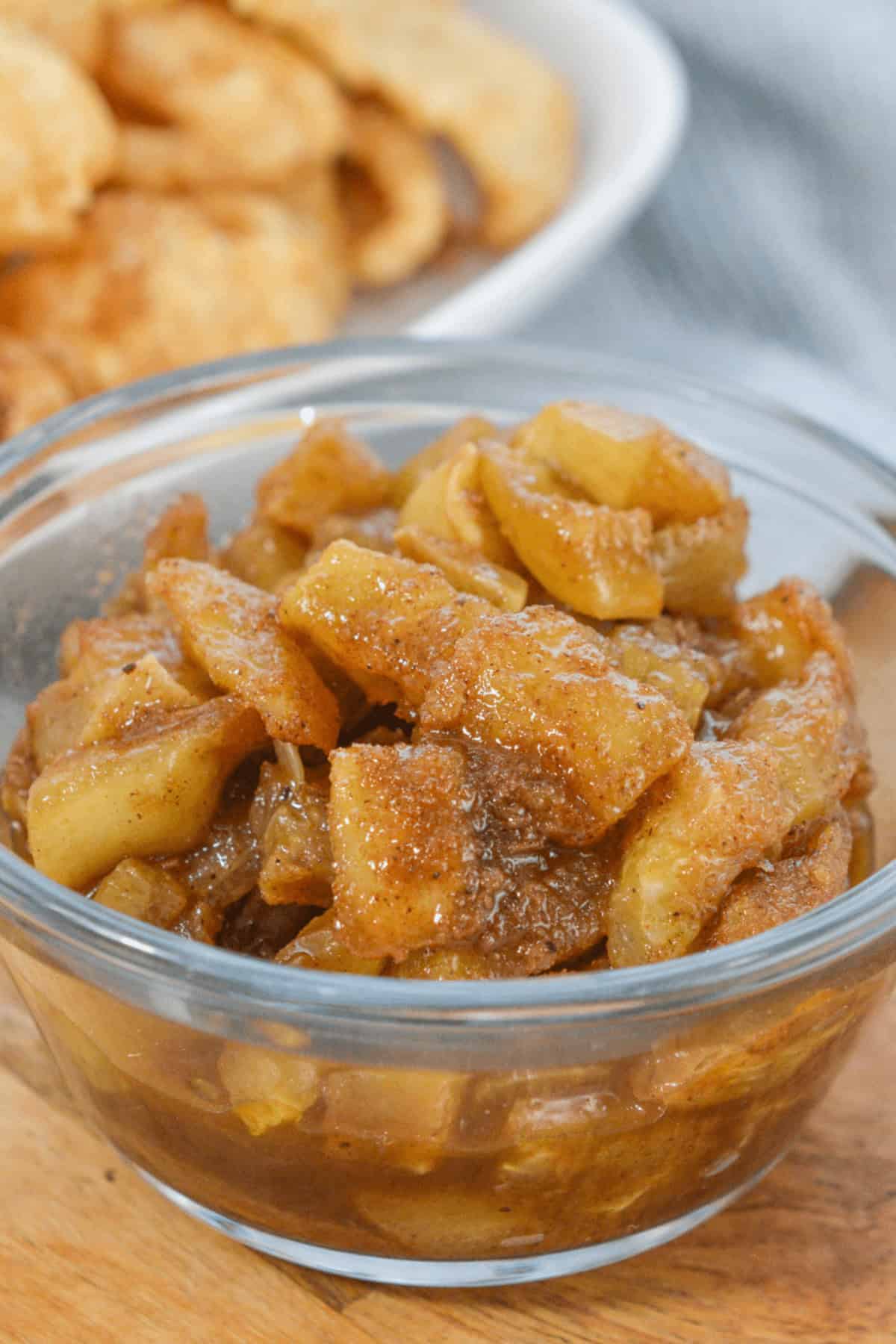 A bowl of cinnamon and brown sugar fruit in a clear glass bowl.