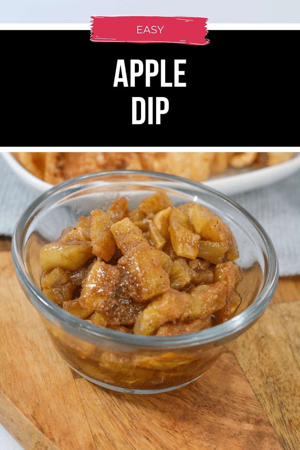 A glass bowl brimming with easy spiced apple dip sits gracefully on a wooden board, with a hint of a plate peeking from the background.