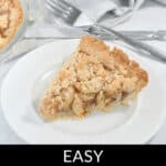 A slice of Easy Apple Pie with crumb topping on a white plate next to a fork. Text at the bottom reads, "Easy Apple Pie w/ Crumb Topping.