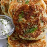 A tray of the fried mashed potato cakes with sour cream dipping sauce.
