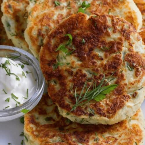 A tray of the fried mashed potato cakes with sour cream dipping sauce.