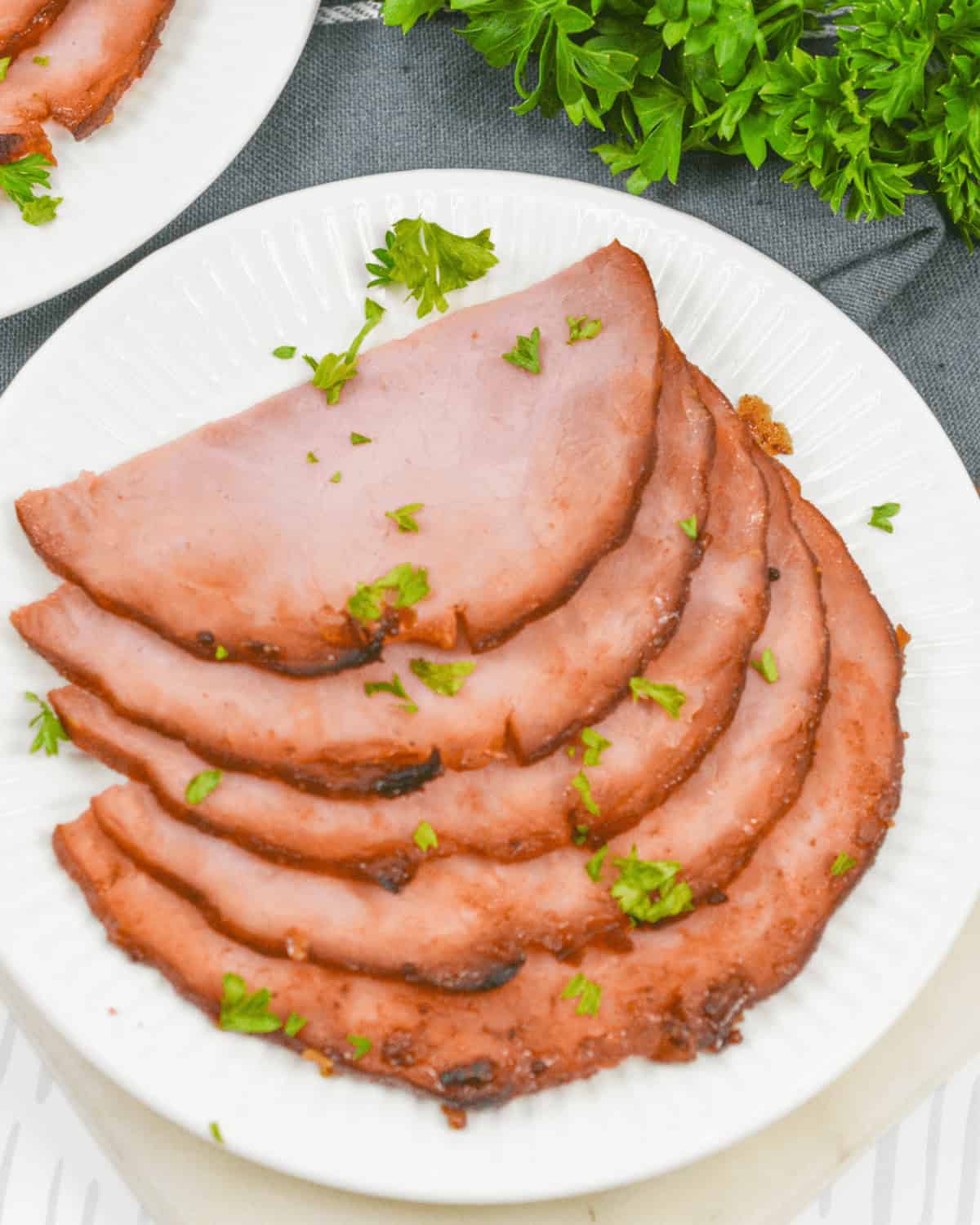 A plate of the meat with parsley on a white plate.