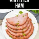 Air Fryer Ham served on a white plate with garnish.