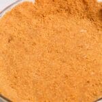 A close-up of a glass pie dish showcases a perfectly pressed Graham Cracker Pie Crust, ready for filling.