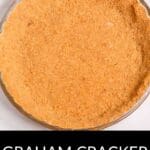 A clear glass pie dish filled with a Graham Cracker Pie Crust is viewed from above. Text at the bottom reads "Graham Cracker Pie Crust.