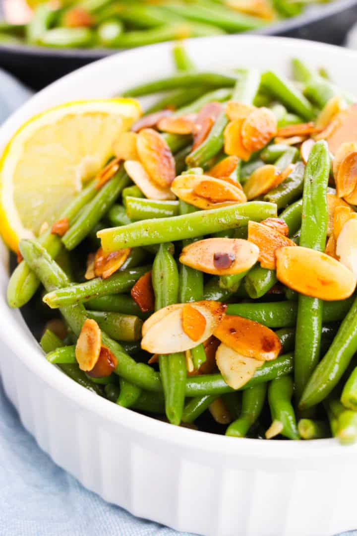 White casserole dish of Green Bean Almondine.