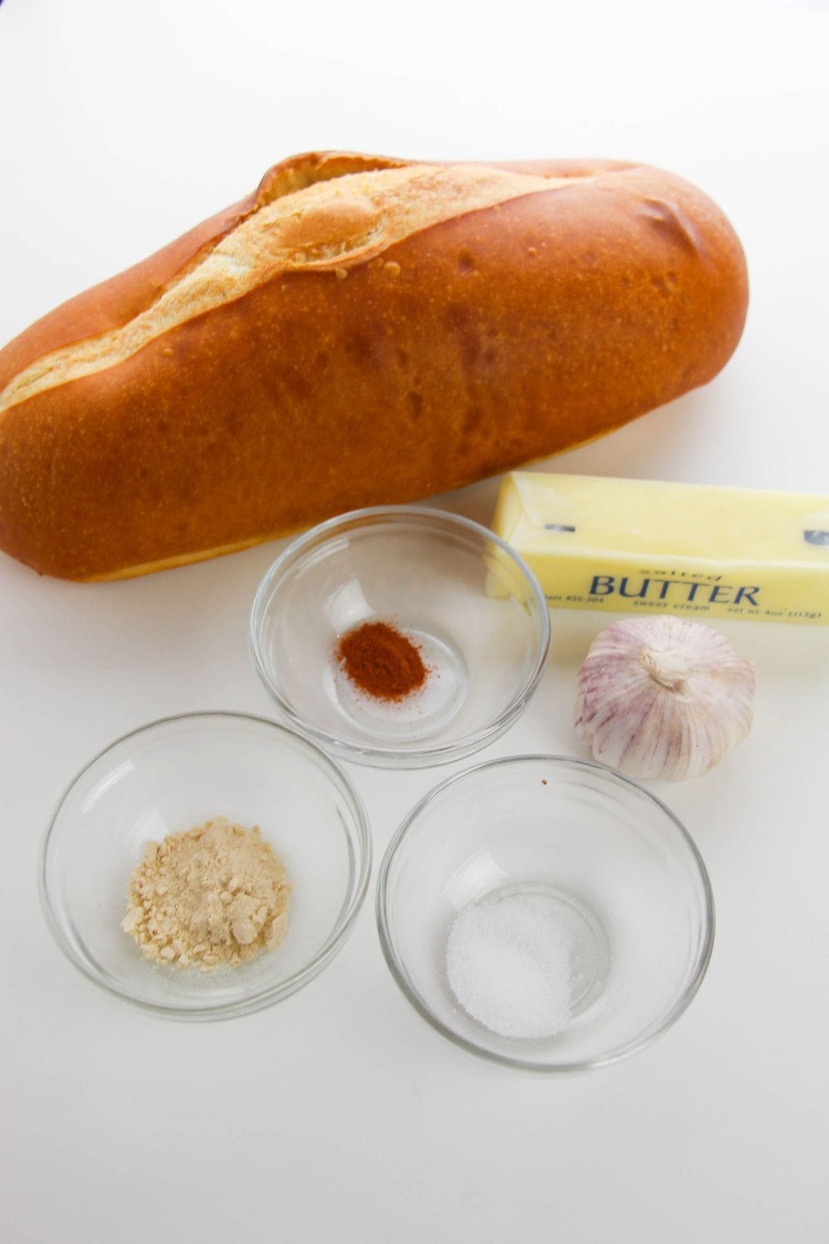 A loaf of  a stick of butter, and seasoning.