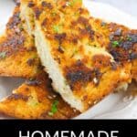 Three slices of golden brown Homemade Garlic Bread are stacked on a white plate, garnished with chopped parsley. Text at the bottom reads "Homemade Garlic Bread.