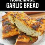 Three slices of crispy Homemade Garlic Bread garnished with herbs, arranged on a white plate.