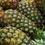 A carton of whole pineapples.