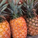 A variety of whole pineapples.