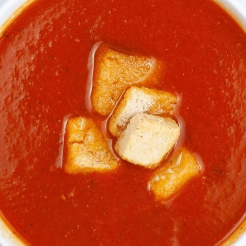 Instant Pot Tomato Soup garnished with crunchy croutons.