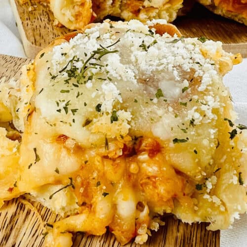 Close-up of the meal sprinkled herbs, grated cheese.