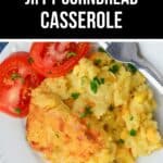 A serving of Jiffy Cornbread Casserole with corn, topped with chopped parsley and sliced tomatoes, served on a white plate with a fork.