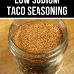 Glass jar filled with low sodium taco seasoning on a wooden surface, labeled 'homemade' at the top in a promotional style.