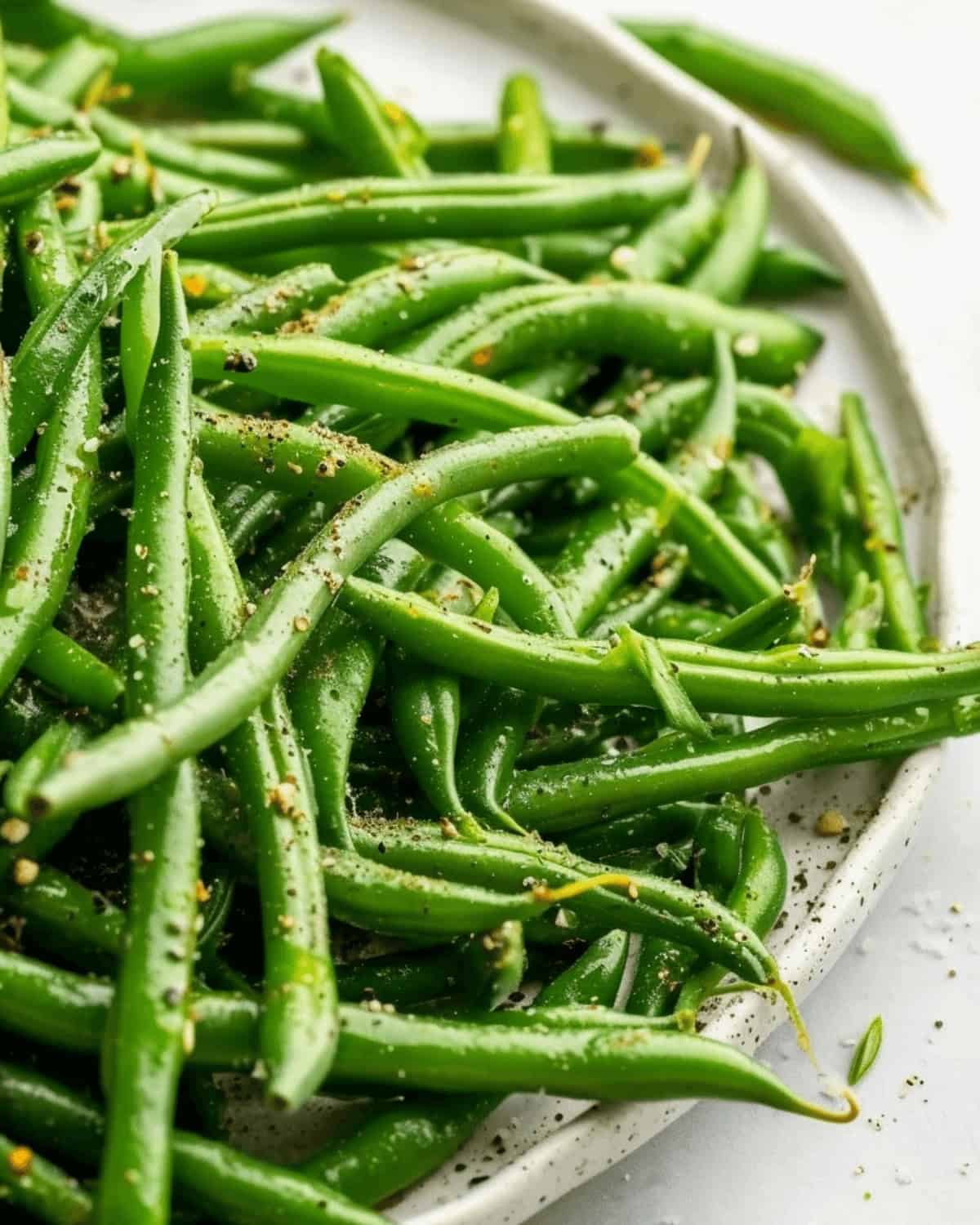 Italian green beans on a white plate.