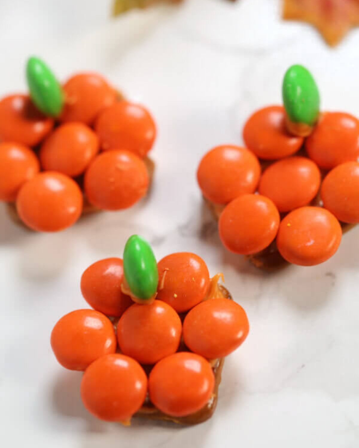 Three pretzel pumpkins with little green stems.