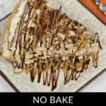 A slice of no-bake Butterfinger pie drizzled with luscious chocolate and caramel sauce sits beautifully on a square plate.