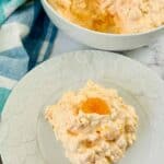 A bowl and a serving of the orange fluff salad.