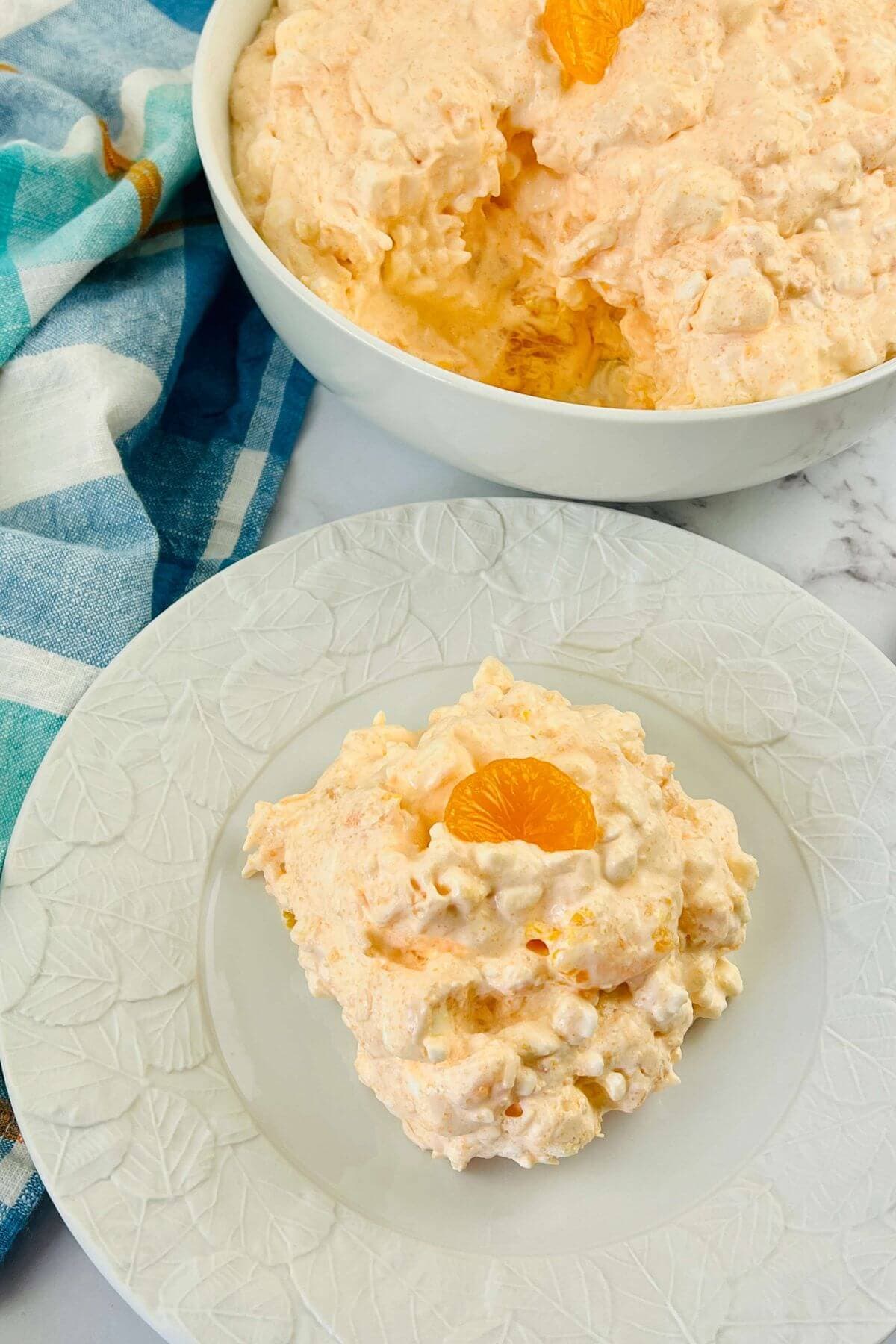 A bowl and a serving of the orange fluff salad.