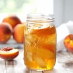 Fresh peaches and a jar of the drink.