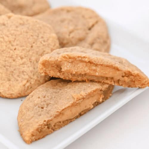 Peanut butter stuffed cookies on a white plate.